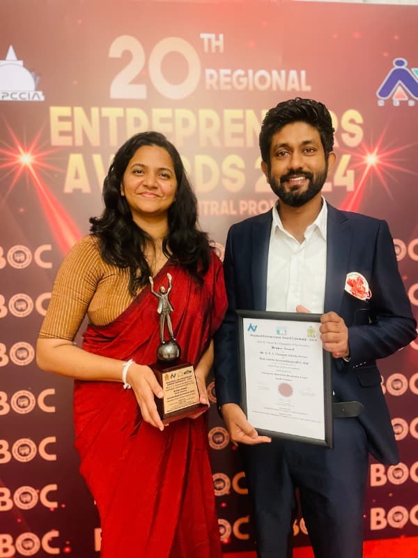 Hotzy Foods founders holding an award certificate at a regional entrepreneurs event